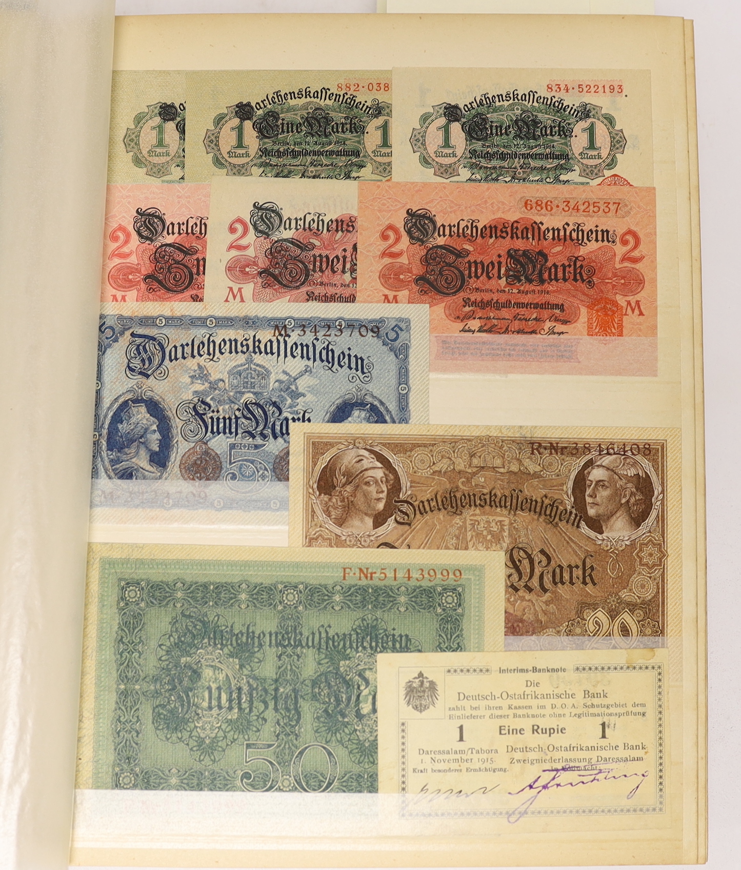 A large collection of German States and City banknotes, 1914-24, and Reichsbank notes from 1904-1948, the majority in near mint condition and a German East Africa one rupee banknote 1 November 1915, in two albums